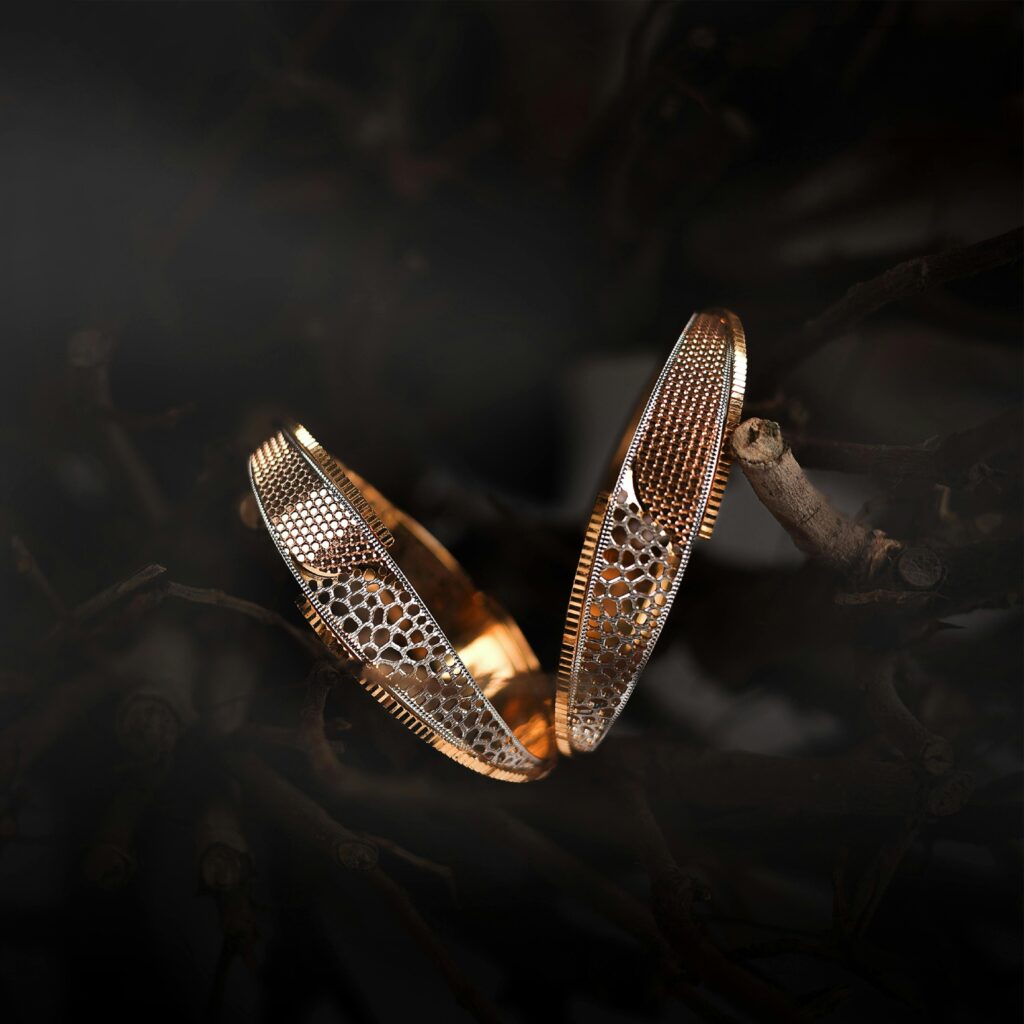 Golden jewelry pieces intricately designed, showcased with an artistic flair in a dramatic setting.