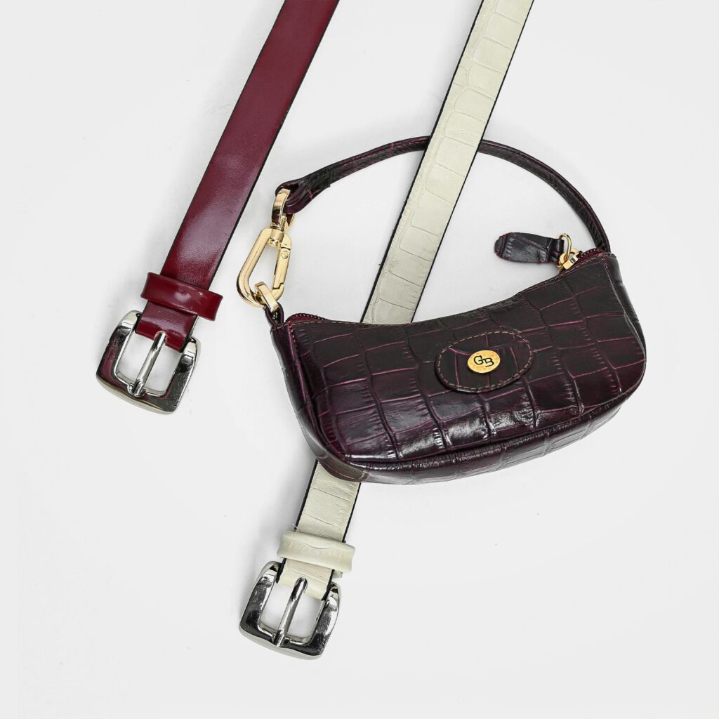 Luxury leather accessory with elegant belts featuring chrome buckles, perfect for fashion enthusiasts.