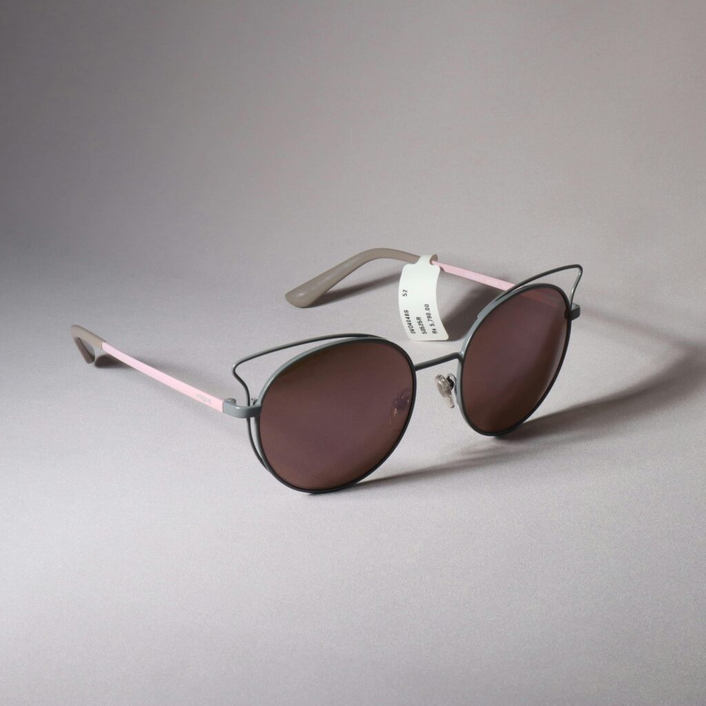 Chic heart-shaped sunglasses with pink and gray frames, perfect for a stylish look.